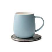 OHOM - Ui 3 Self-heating Mug Set: Jasmine White, featuring a pale-blue ceramic mug on an electric warmer base, ideal for keeping beverages at optimal temperature.