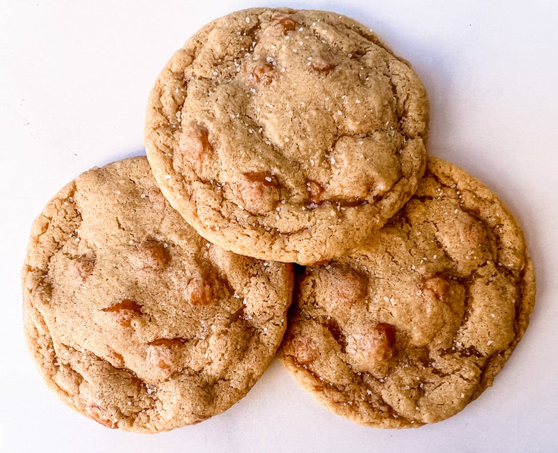 Southern Roots Sisters - Salted Caramel Cookie Mix: Three golden-brown cookies with caramel chips and sea salt, showcasing sweet-savory perfection for Athens Cooks' curated kitchen delights.