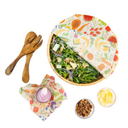 Bee's Wrap - New! Garden Party - Assorted 3 Pack displayed with salad, utensils, and nuts, showcasing reusable food storage wraps for preserving fresh produce.