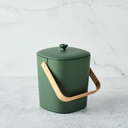 Bamboozle - Astrik Composter: Forest, a green bucket with a wooden handle designed for sustainable composting, ideal for stylish kitchen countertops.