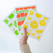 Bespoke Provisions - Lemons Swedish Dishcloth held in hand, featuring fruit designs. Made from cotton and cellulose, it's a sustainable cleaning alternative, perfect for kitchen use.