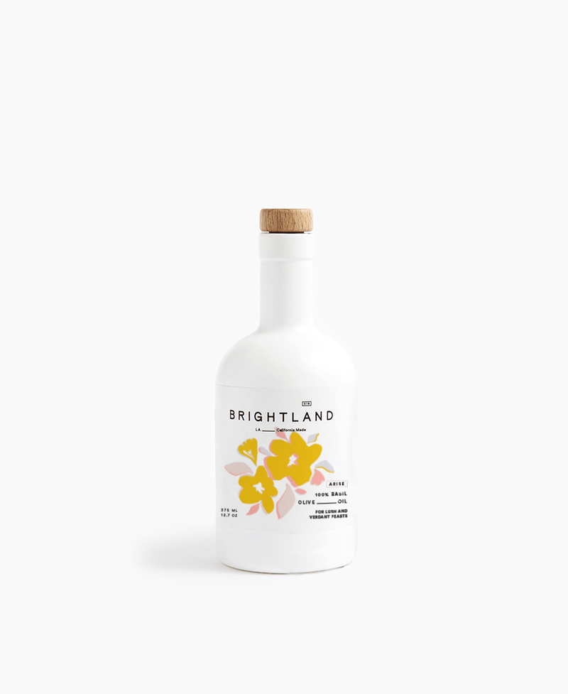 Brightland - ARISE Basil Infused Olive Oil in a UV-coated glass bottle featuring a yellow flower design, perfect for gifting and culinary use.