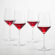 Zwiesel Fortessa | Pure Cabernet Glass, Single: A clear, elegantly designed wine glass, filled with red wine, showcasing its angled bowl and sophisticated stem, ideal for enhancing your drinking experience.