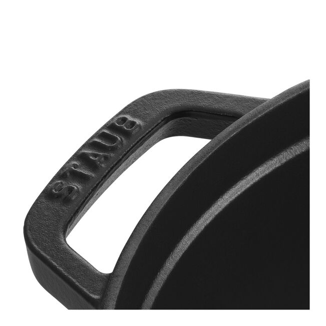 Staub Round Cocottes - 7 qt Matte Black with a close-up of the cast-iron handle, showcasing the rough-textured finish and STAUB engraving.
