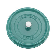 Staub 5.5 qt Round Cocotte lid in teal with stainless-steel knob and LA COCOTTE STAUB embossed, showcasing premium enameled cast-iron craftsmanship.