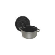 Staub | Round Cocottes - 7 qt Graphite, features a self-basting lid with nodules, ideal for slow-cooking, showcased with lid behind and empty interior.