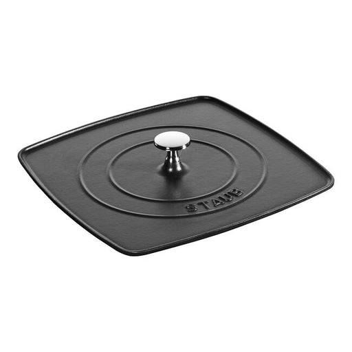 Staub Cast Iron Square Grill Press in black, featuring a heavy, enameled finish with concentric rings and a central stainless-steel knob for even browning and moisture retention.