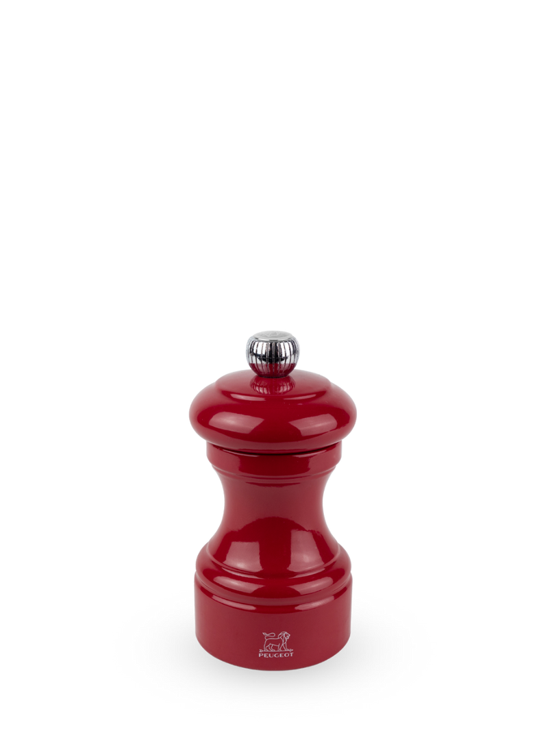 Peugeot | Bistro Salt Mill in Passion Red, featuring a glossy enamel finish, chrome knob, and iconic lion logo, offering adjustable grinding with lifetime warranty.