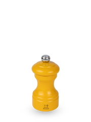 Peugeot | Bistro Pepper Mill, Saffron: A small, bright yellow, hourglass-shaped manual grinder with a metal knob and Peugeot logo, crafted sustainably in France.