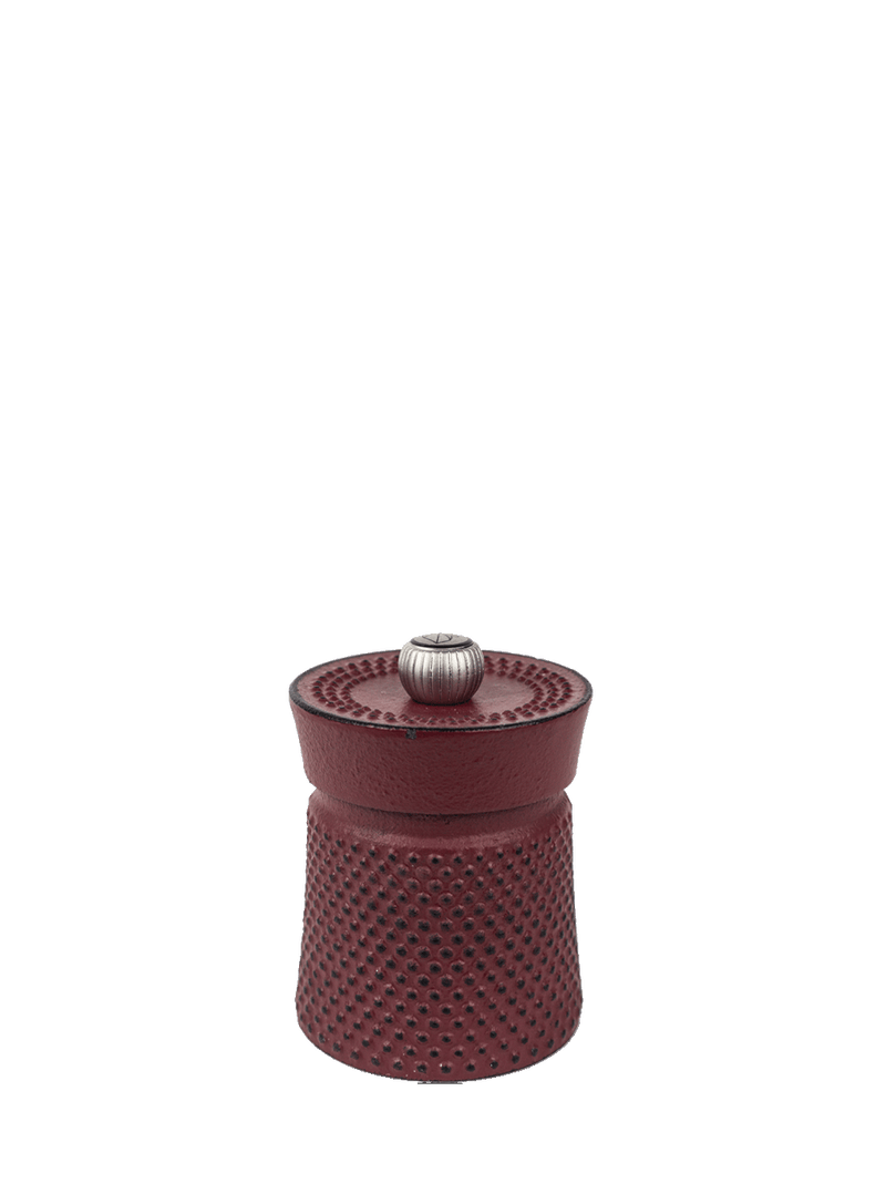 Peugeot | Bali Cast Iron Pepper Mill, Red: Compact dimpled cast-iron grinder with adjustable metal knob, combining traditional craftsmanship with modern elegance for an exquisite dining experience.