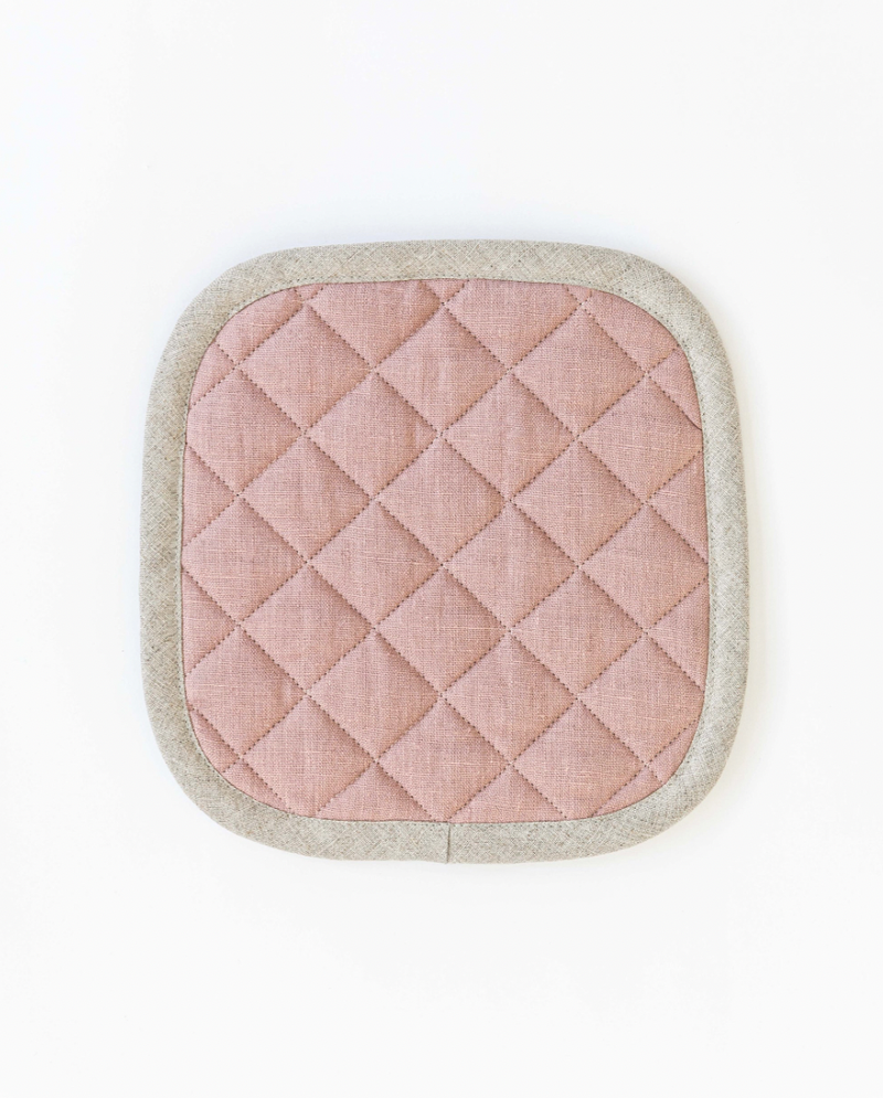 MagicLinen linen pot-holder with quilted design and white border, featuring a hanging loop for easy storage. Ideal for heat insulation while cooking.