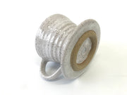 RachaelPots - Coffee Pour Over Cone W/Handle: Pink, hand-thrown stoneware with a speckled finish, flared rim, and handle, shown lying on its side.