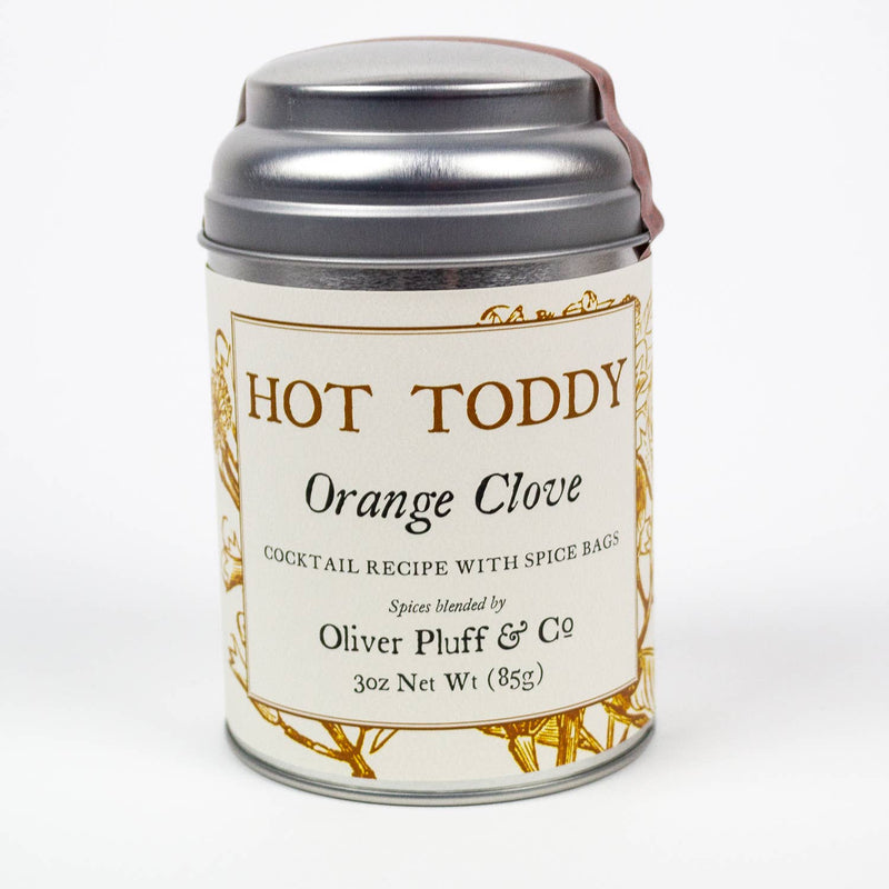Oliver Pluff & Company - Orange Clove Hot Toddy Kit in a cylindrical metal tin, featuring spice bags for crafting hot toddy cocktails with cinnamon, orange peel, and cloves.