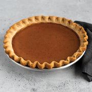 Nordic Ware | Naturals® High Dome Covered Pie Pan with plastic dome cover, showcasing a pie inside, highlighting its spacious design to protect toppings and maintain freshness.