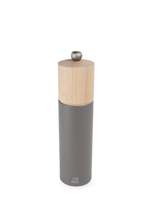 Peugeot | Boreal Pepper Mill, Rock Gray: A tall, cylindrical tabletop grinder with a wooden top and matte grey metal body, featuring Peugeot's durable steel mechanism.