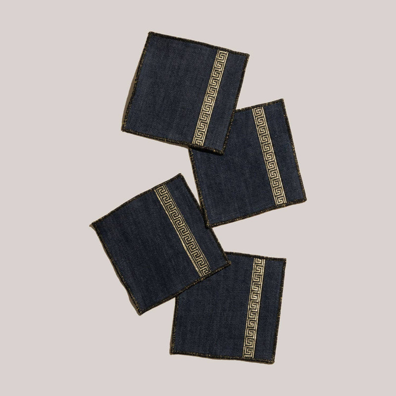 ATELIER SAUCIER - Grecian Cocktail Napkins | Set of 4: Dark-wash denim napkins with gold Greek-key trim and edges, perfect for elegant gatherings.