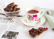 Norwegian Baked - KnekkeGodis Valentine's Special, featuring a cup of tea and chocolate-covered granola bars on a plate, a Nordic sweet treat.