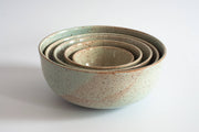 RachaelPots - Nesting Bowls Set of Five: Light Blue, showcasing a stack of handmade stoneware bowls with speckled finish, ideal for diverse kitchen uses.
