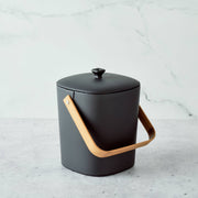 Bamboozle - Astrik Composter: Graphite, a matte-black, rounded compost bin with bamboo handle, designed for sustainable kitchen use and odor control.