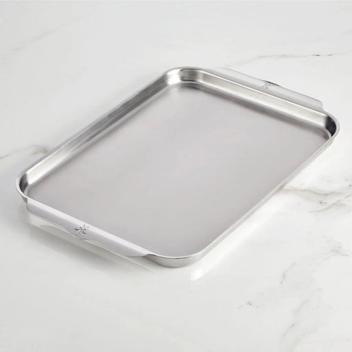 Hestan | OvenBond Tri-Ply Bakeware, Single Half Sheet Pan with rolled edges and built-in handles, showcased on a marble-style countertop, ideal for even heat distribution and durability.