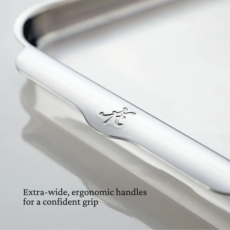 Close-up of Hestan | OvenBond Tri-Ply Bakeware Half Sheet Pan, showcasing extra-wide ergonomic handles for secure grip, ideal for even heat distribution in baking and roasting.