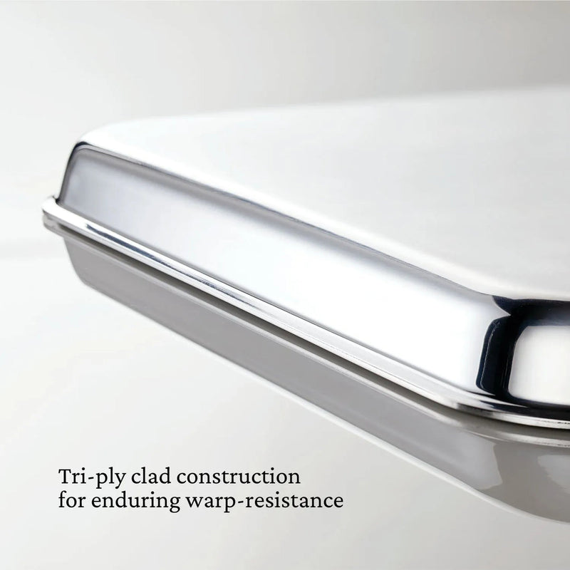 Hestan | OvenBond Tri-Ply Bakeware, Single Half Sheet Pan, shown with its warp-resistant tri-ply clad construction and wide handles for easy oven removal.