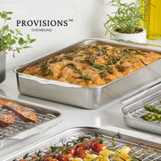 Hestan | Oven Bond Tri-Ply Bakeware, Rectangular Baker with focaccia bread, surrounded by smaller pans with roasted vegetables, highlighting durable stainless steel craftsmanship.