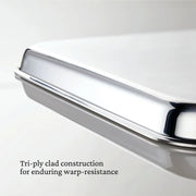 Hestan | Oven Bond Tri-Ply 5 Piece Set pan close-up highlighting tri-ply clad edge, illustrating its warp-resistant design with wide curved handles for safe, easy handling.