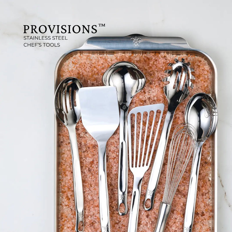 Hestan Provisions | Stainless Steel Ladle, 13 (5oz) showcased with matching chef's tools on a tray of pink salt, highlighting its elegance and craftsmanship.