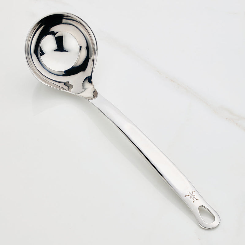 Hestan Provisions | Stainless Steel Ladle, 13 (5oz) on countertop, showcasing its deep bowl, ergonomic handle, and polished finish designed for effortless, drip-free pouring.
