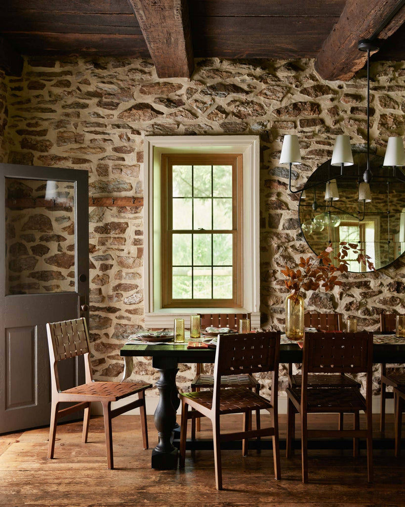 Coral & Tusk - Pressed Leaves Dinner Napkin adorns a rustic dining table, enhancing the cozy farmhouse setting with its autumn leaf design amidst elegant tableware.