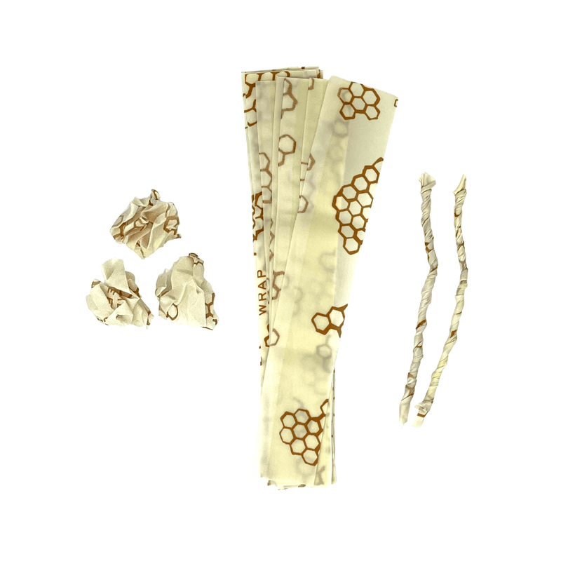 Bee's Wrap - ReKindle Fire Starters™: A stack of reusable beeswax-coated wraps with honeycomb pattern and strips, ideal for eco-friendly fire starting in camping or cooking.