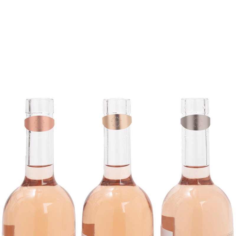 L'Atelier du Vin - USA - Drop Stopper - LE TRIO WINE RINGS on clear bottles, featuring pink, silver, and gold matte memory metal with absorbent felt.