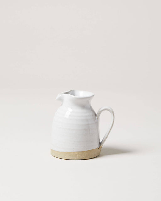 Farmhouse Pottery - Bell Pitcher: A handcrafted, off-white ceramic creamer with a spouted rim and curved handle, ideal for serving dressings or syrups.