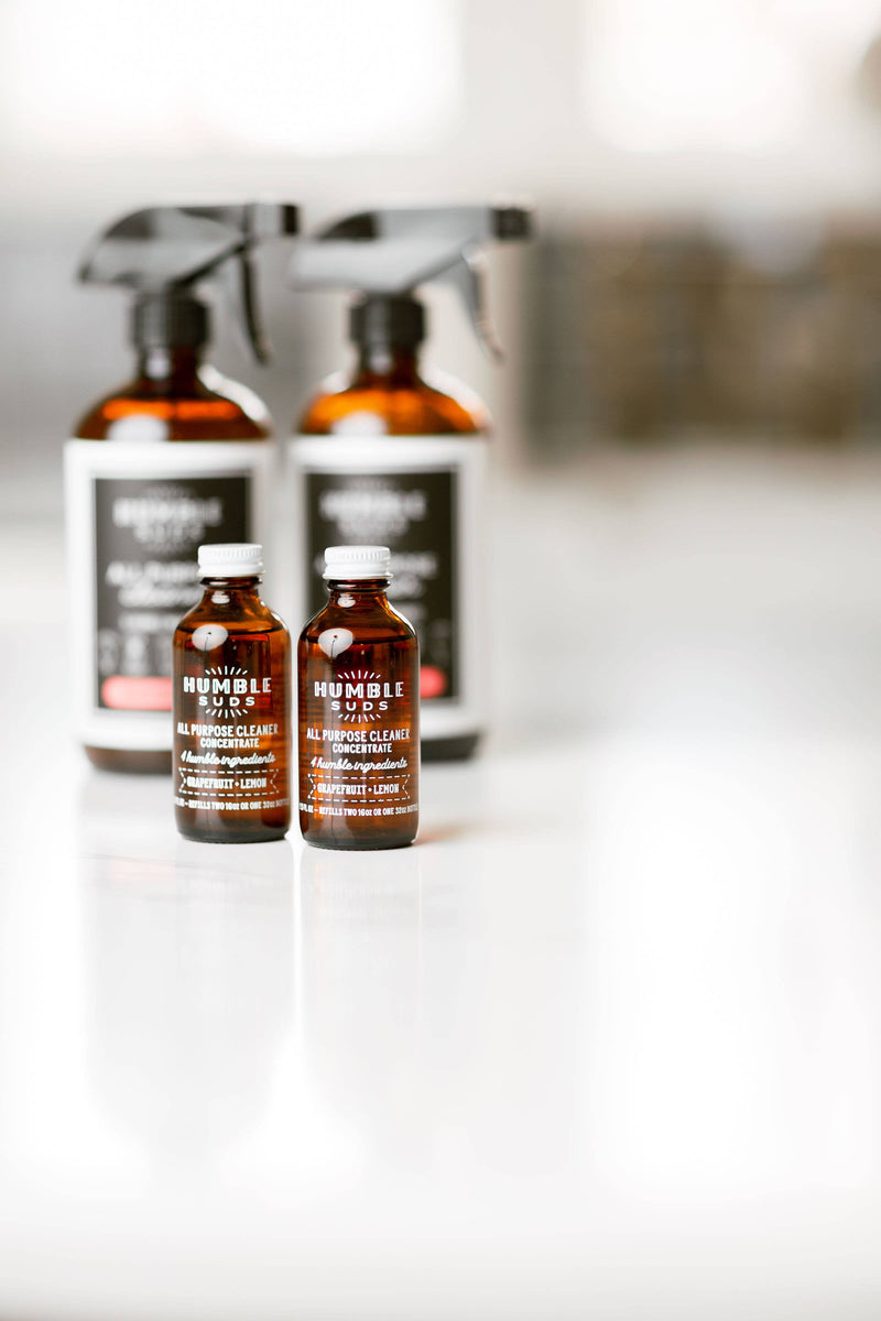 Close-up of Humble Suds All Purpose Concentrate - Orange & Clove, a 1.5 oz eco-friendly glass bottle with concentrated cleaning formula, ideal for zero-waste homes.