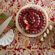 Couleur Nature - Noel Red & Green French Tablecloth: 71 x 71 displayed under a fruit tart with berries, emphasizing holiday charm and artisan craftsmanship.