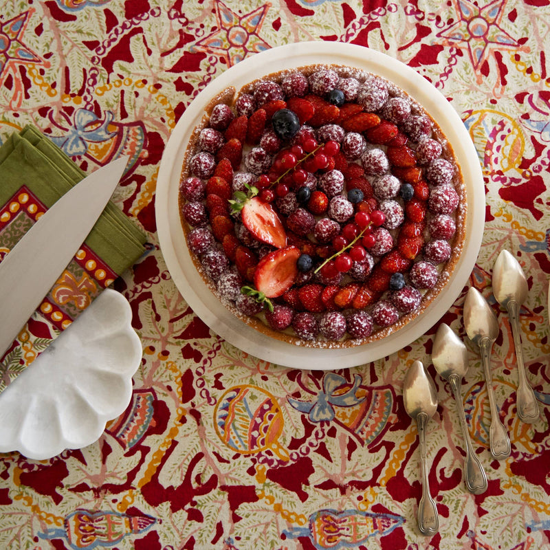 Couleur Nature - Noel Red & Green French Tablecloth: 71 x 71 displayed under a fruit tart with berries, emphasizing holiday charm and artisan craftsmanship.