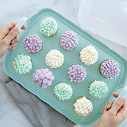 Nordic Ware | Cakes and Cupcakes Carrier showcasing cupcakes with frosted tops on a tray, highlighting its versatile design for transporting baked goods.