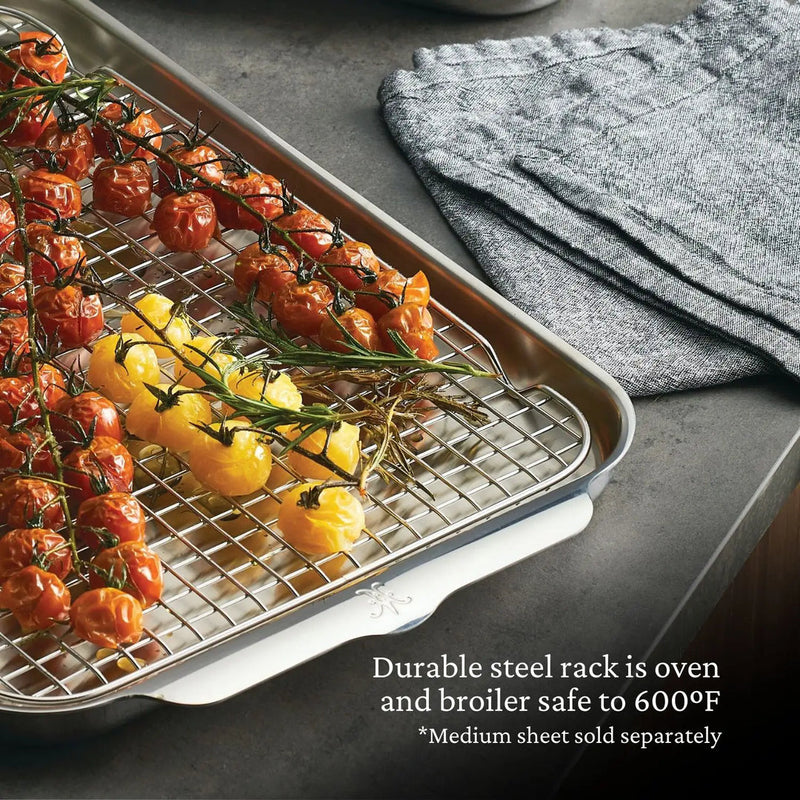 Hestan | OvenBond Tri-Ply Bakeware, Medium Rack Only, set in a sheet pan with cherry tomatoes and rosemary, showcasing its oven-safe durability and versatile culinary use.