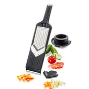 GEFU Violi 2.0 Adjustable Mandoline with grater and slicer, surrounded by assorted vegetables like cucumbers and tomatoes, ideal for versatile kitchen prep at Athens Cooks.