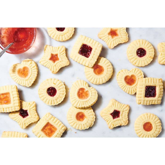 Assorted jam-filled cookies made with the HIC - Harold Import Co. - King Arthur Thumbprint Cookie Cutters 4-Piece Set, featuring heart, star, square, and round shapes.