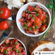 Rustic tomato salad with fresh herbs and crusty bread, ideal for enhancing with Burlap & Barrel - Cured Sumac for added brightness and flavor.