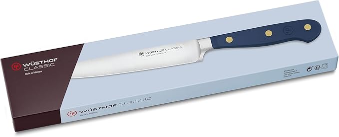 Wüsthof Classic 6 Utility Knife Wild Blueberry displayed on a branded box, showcasing its sleek blade design. Ideal for precise kitchen tasks.