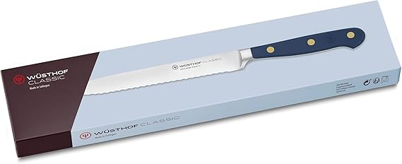 Wüsthof Classic 5 Serrated Utility Knife Wild Blueberry displayed in a box, highlighting its precision blade, perfect for versatile kitchen use.