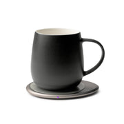 OHOM - Ui 3 Self-heating Mug Set: Jasmine White, featuring a matte-black ceramic mug on an electric warmer with visible LED, ideal for perfectly heated beverages.