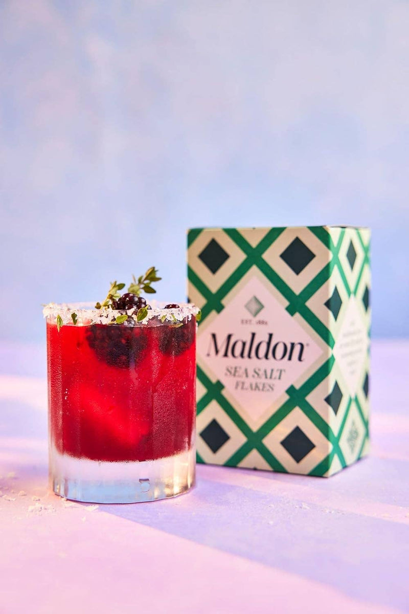 Wholesome Good - Maldon Sea Salt 8.5oz / 12: Single, featured beside a salt-rimmed berry cocktail with fresh herbs, highlighting its premium quality.