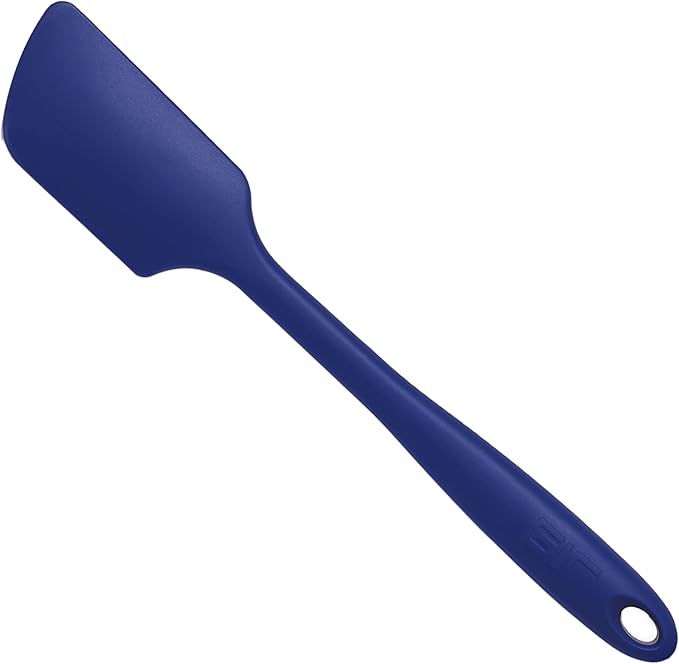 GIR | Ultimate Spatula - Navy, a premium silicone kitchen utensil with a central hole, designed for versatile cooking without scratching pans. Ideal for handling delicate dishes.