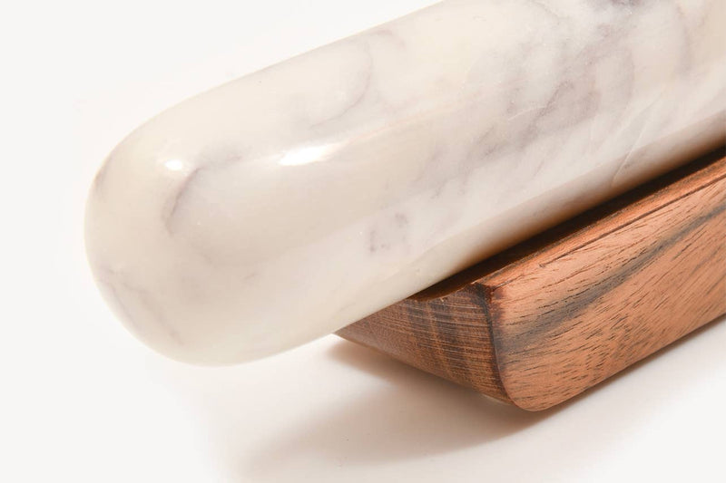 Verve Culture - White Marble Rolling Pin and Wood Base: A polished marble rolling pin with gray veining on a wooden block, ideal for enhancing baking precision and kitchen elegance.