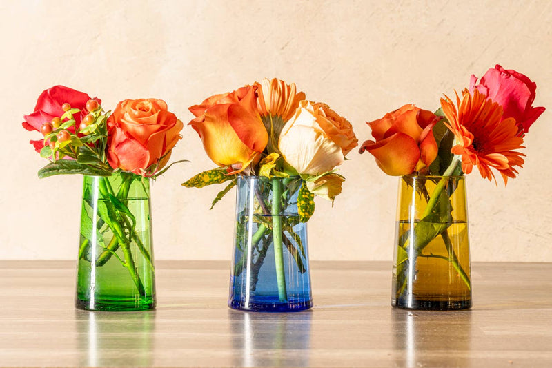 Set of 6 Moroccan Cone Glassware, hand-blown from recycled bottles, featuring unique bubbles and organic shapes, ideal for beverages or as decorative table vases.