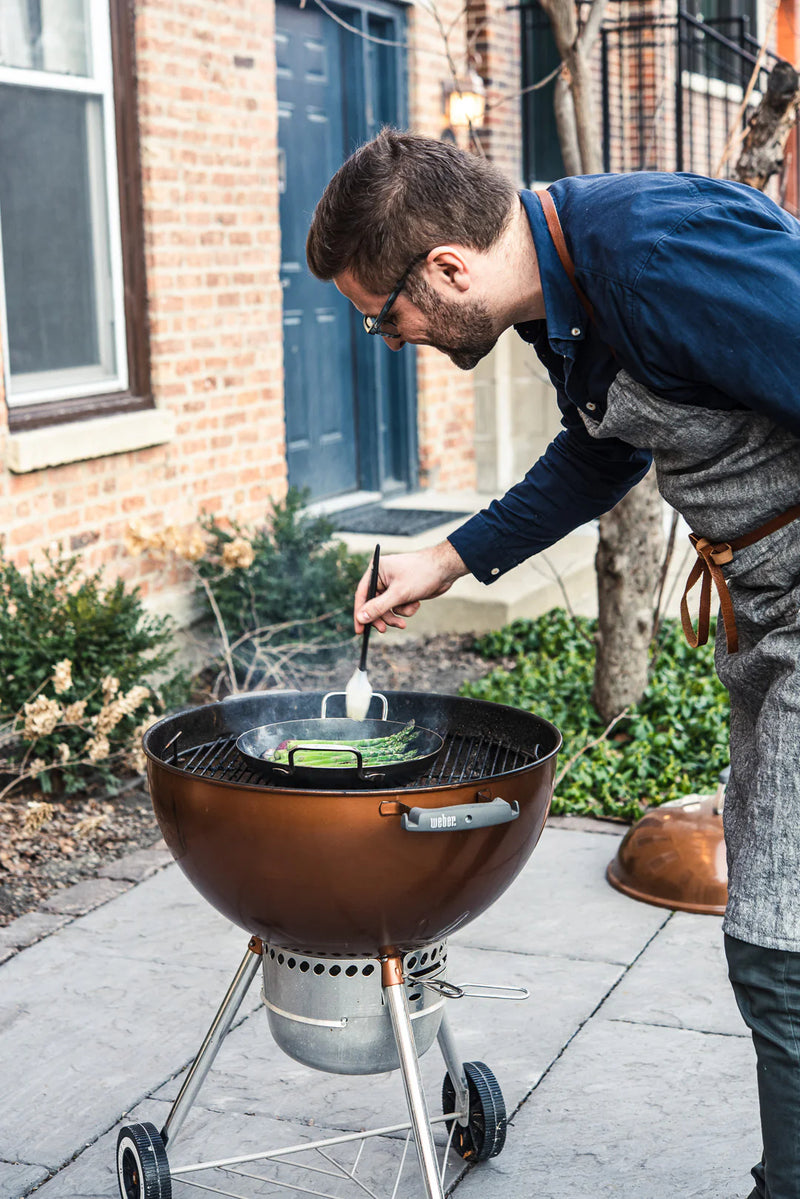 de Buyer | Outdoor Fry Pan - Long Handle, ideal for BBQ, features perforated blue carbon steel for grilling delicate foods, with dual handles for easy maneuvering.